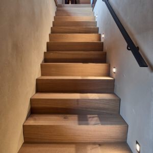 Beleuchtete Holztreppe eines Einfamilienhauses
